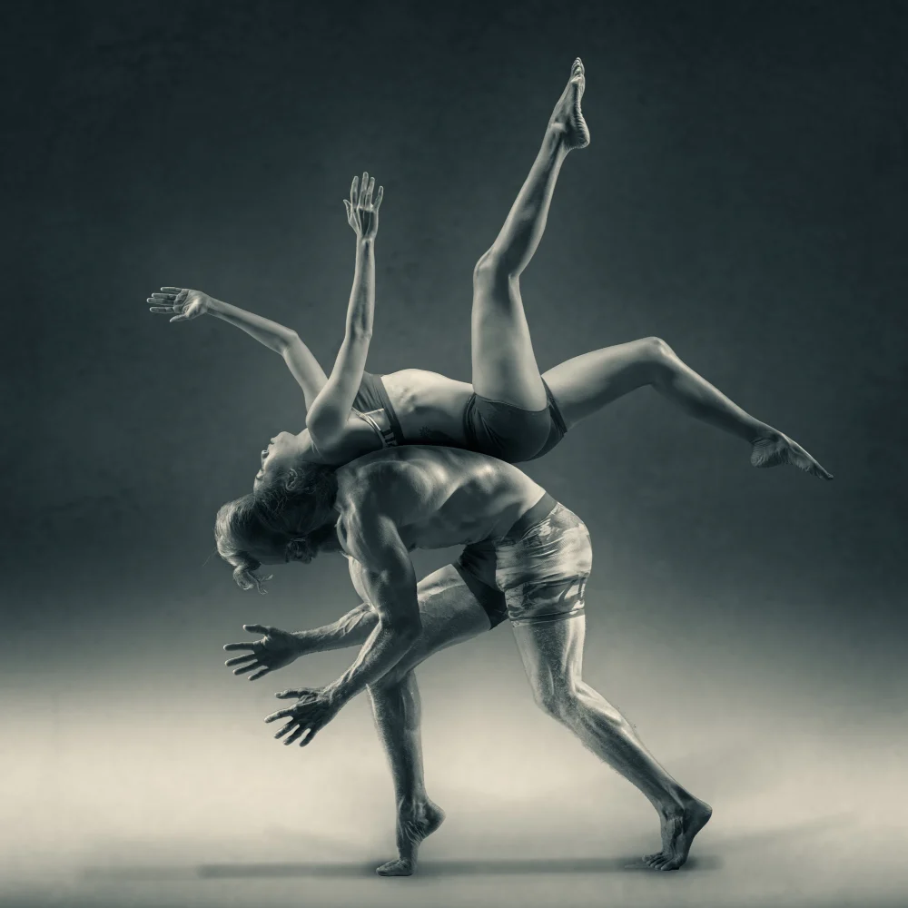 a woman flipping over a man
