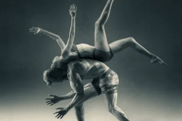 a woman flipping over a man